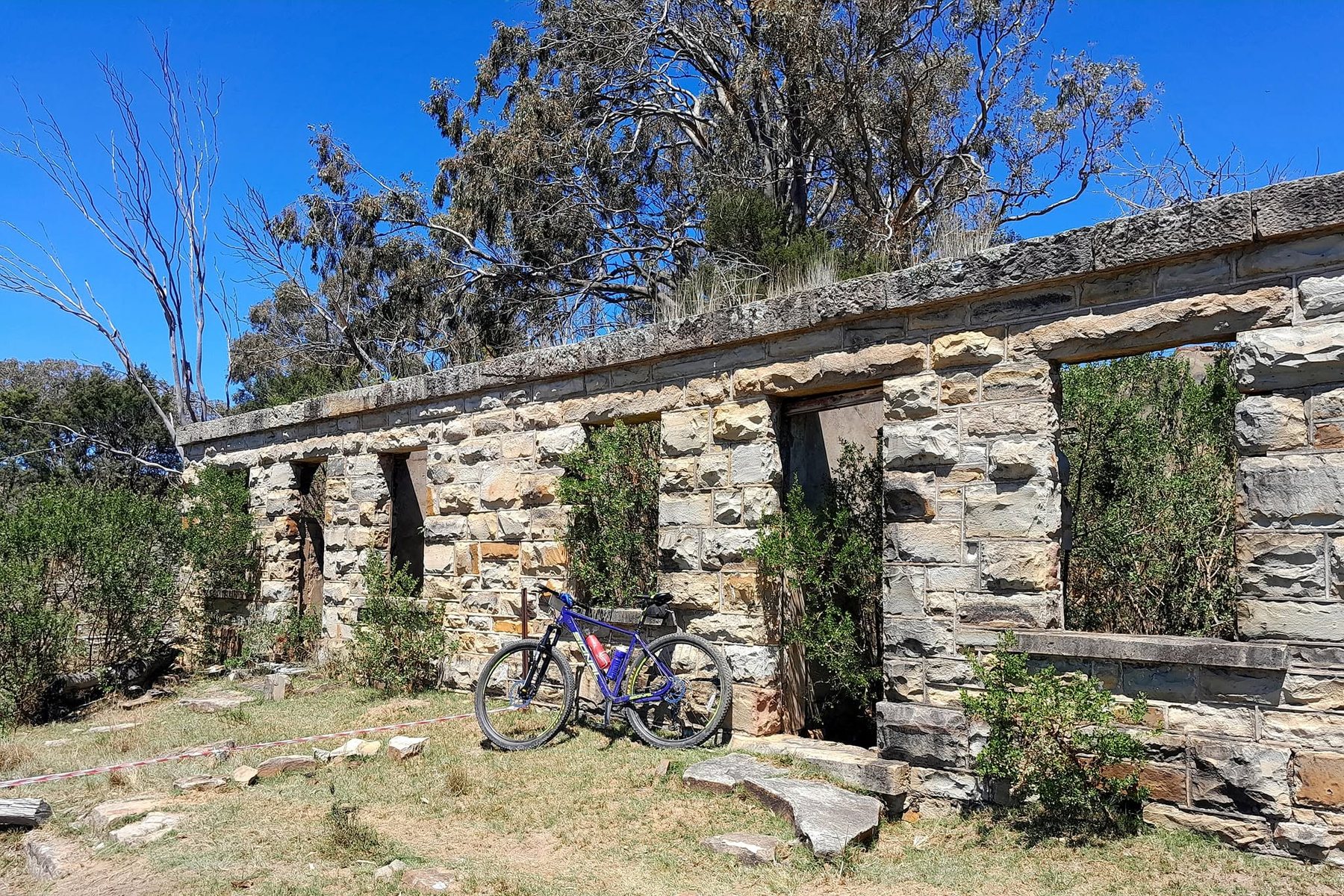 Mountain bike beside historic stone ruins